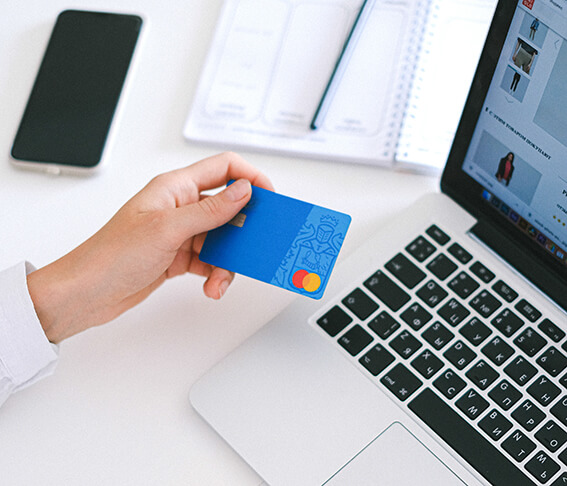Tax accountant holding a card infront of a laptop